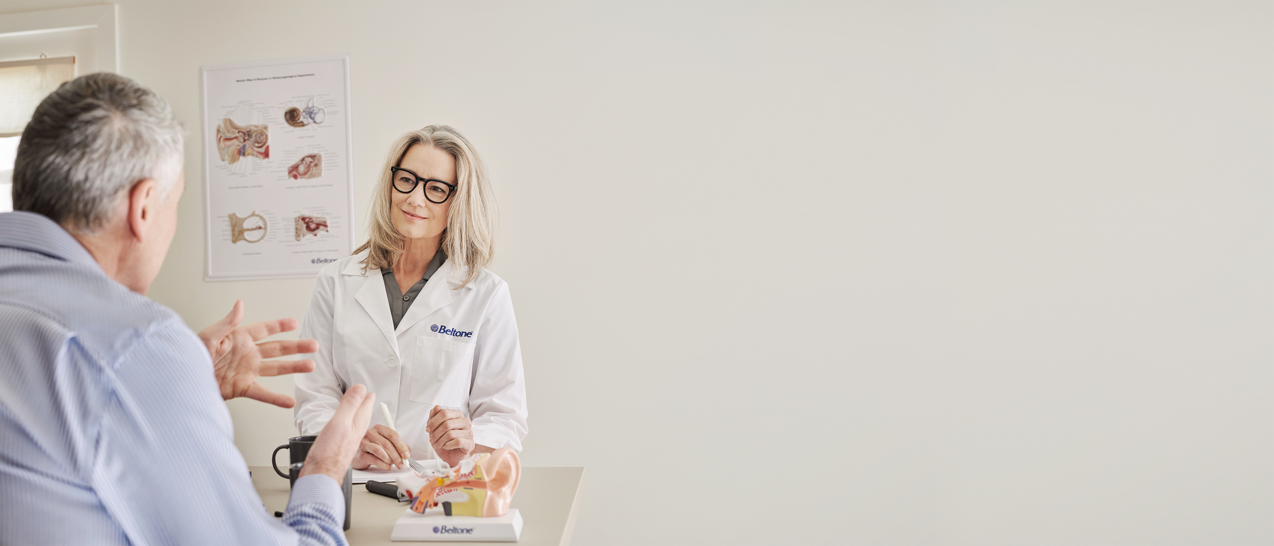 patient visiting Beltone hearing care professional in the clinic