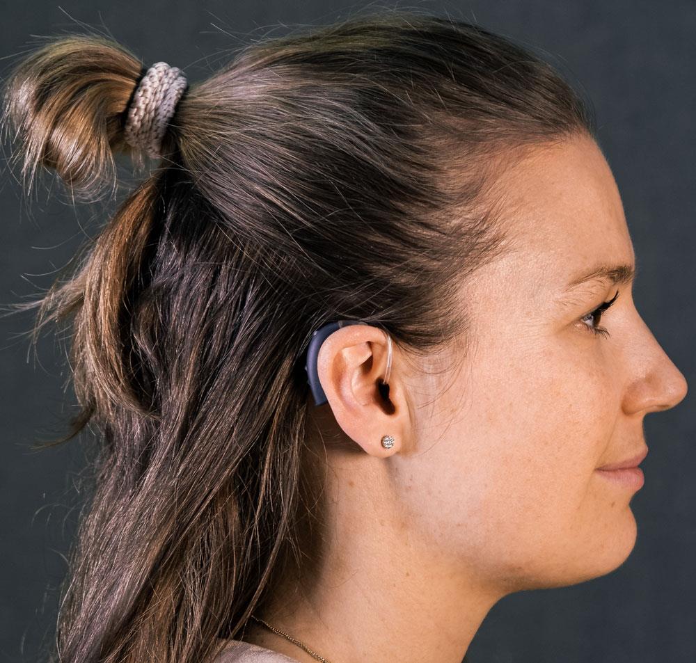 Woman wearing a behind-the-ear (BTE) style hearing aid