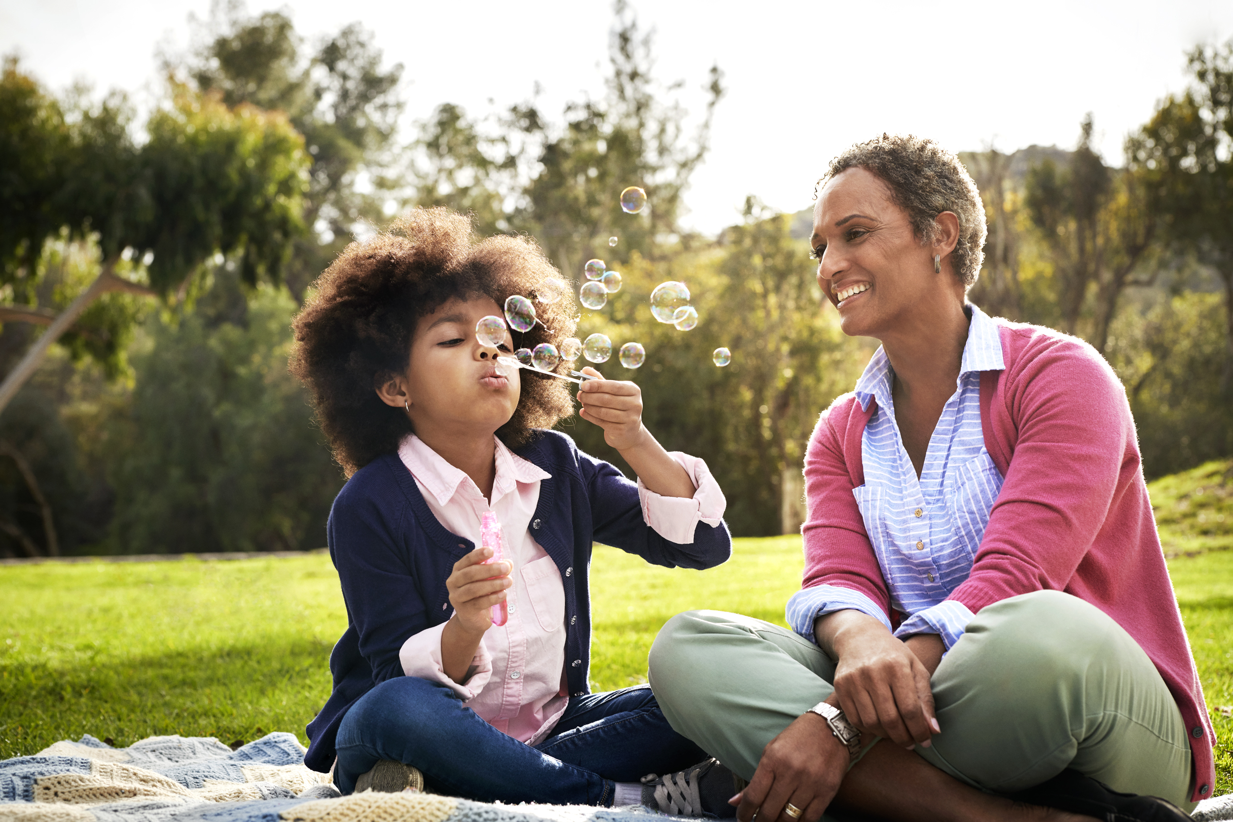 Grandmother enjoying picnic with grandkid