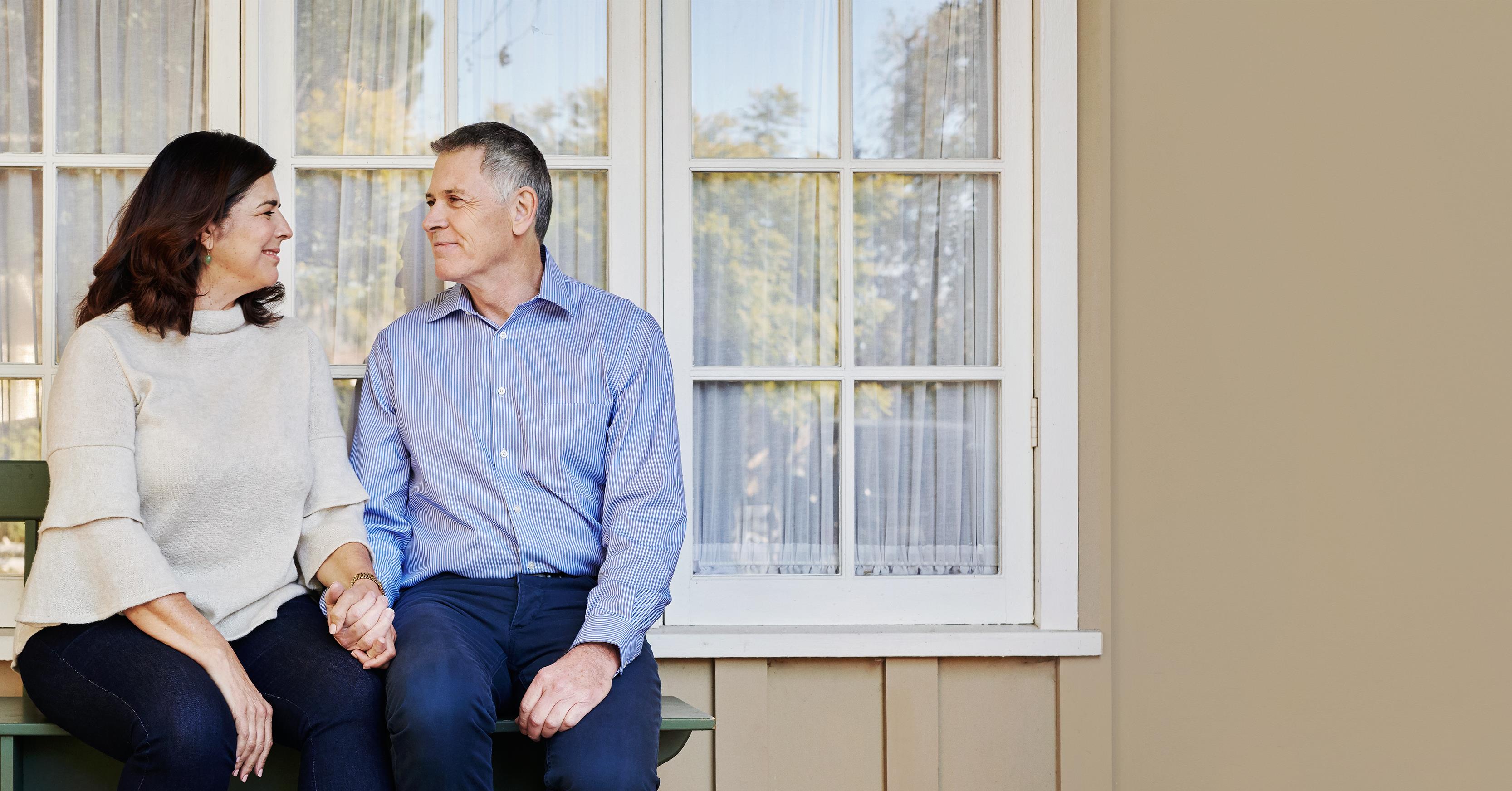 Couple holding hands and sitting on the bench