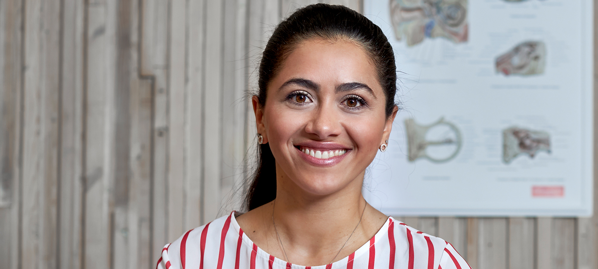 Woman wearing hearing aids and smiling.