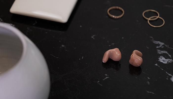 Discreet, practically invisible ReSound Key hearing aids on a table
