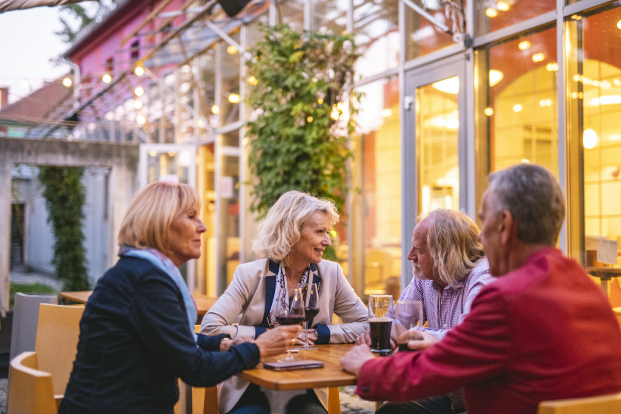 Man with hearing loss in a noisy environment: picnic with family.