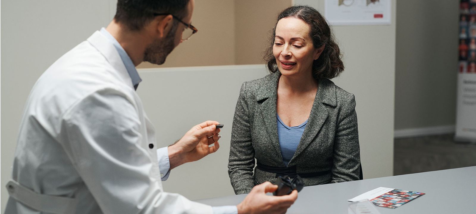 ReSound hearing care professional interacting with a patient during an appointment.