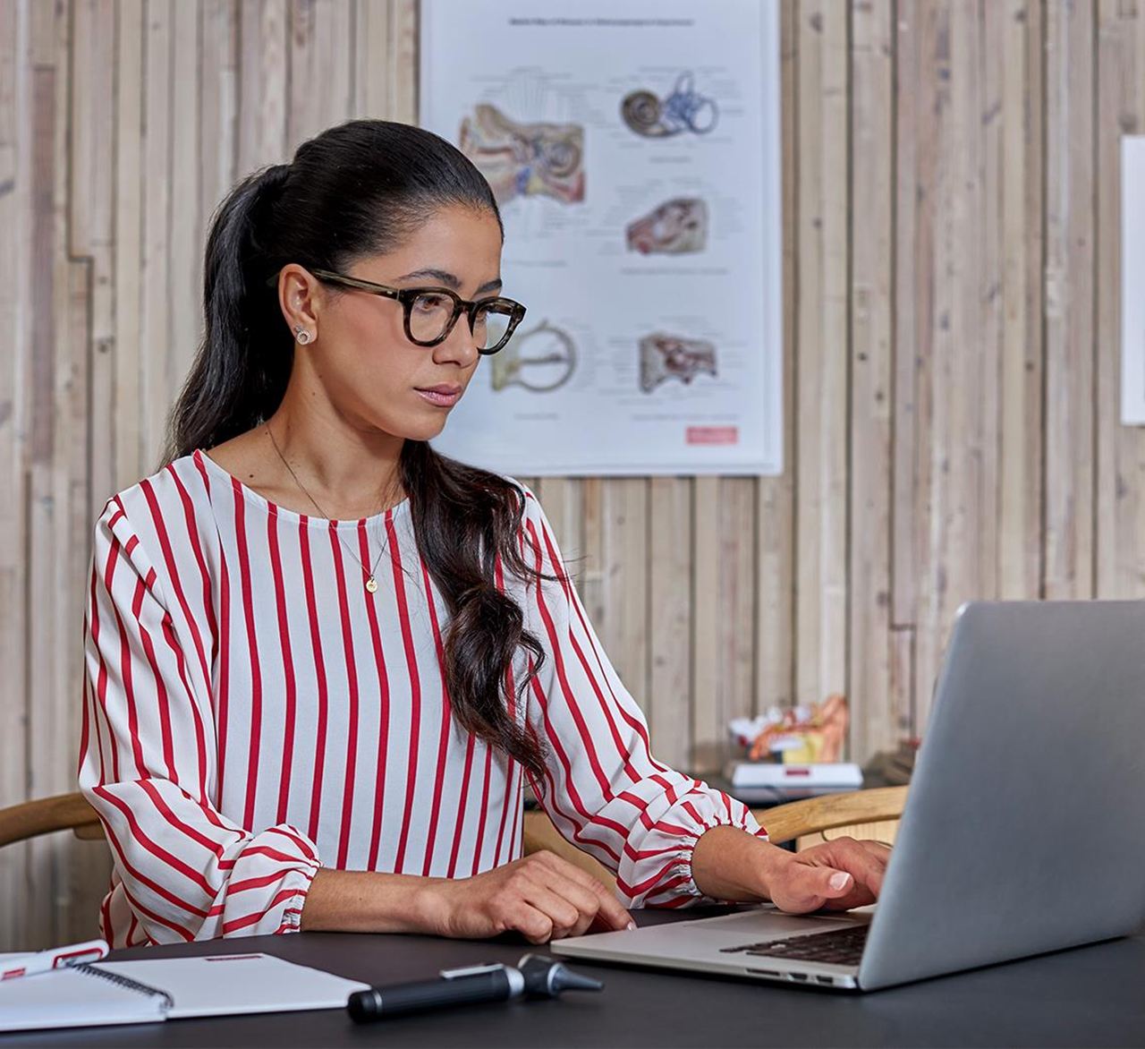 female find a hearing care professional in a consultation explaining about affordable hearing aids