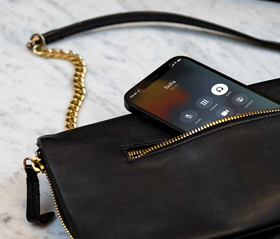 An iPhone 12 in a bag connected to a ReSound ONE hearing aid