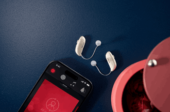 ReSound Smart 3D app and RIE hearing aids on a table