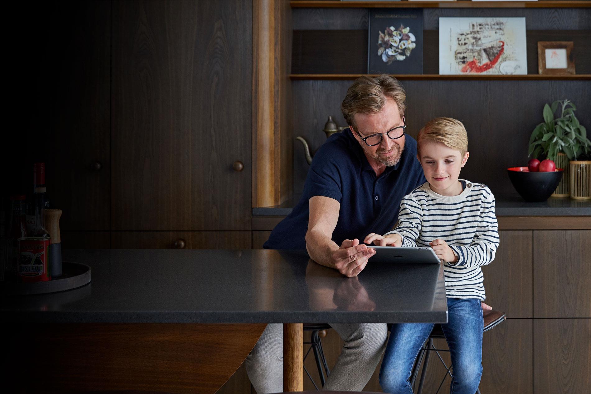 Father and son watching iPad